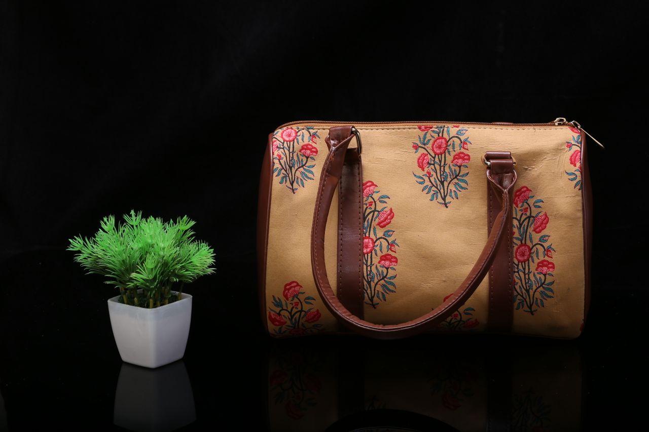 Crafting Captivating Headlines: Your awesome post title goes here Stylish floral leather handbag paired with an artificial plant for a chic look.